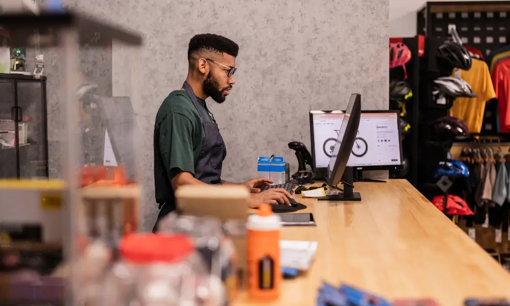 A worker at the main desk behind a screen