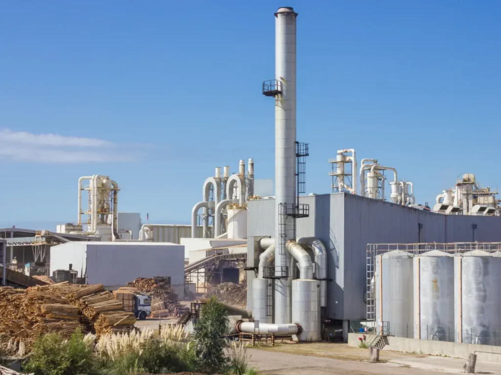 Exterior of a factory with a chimney.