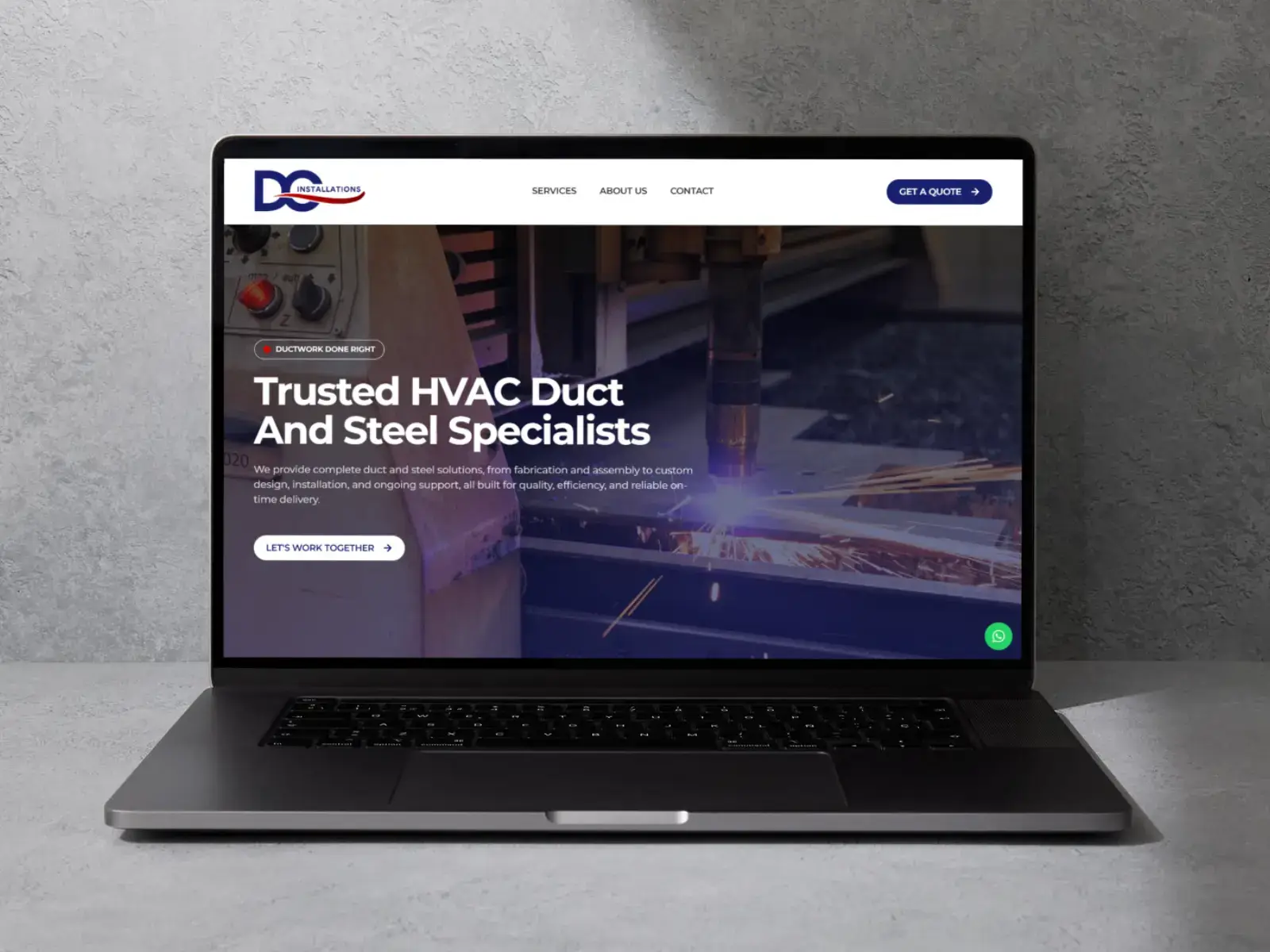The DC Installations website shown on a laptop